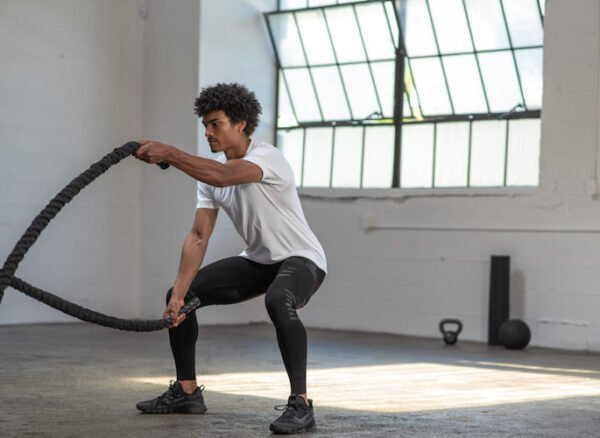 man exercising with two ropes
