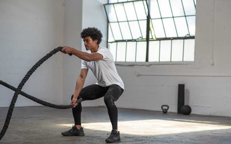 stoko-benefits man exercising with two ropes
