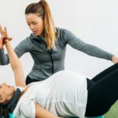 Therapist helping woman do physiotherapy in Vancouver's Olympic Village