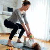 Woman doing post partum physiotherapy with her baby