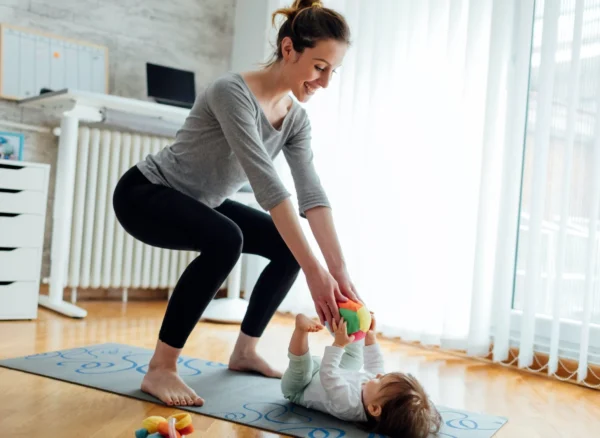 Woman doing post partum physiotherapy with her baby