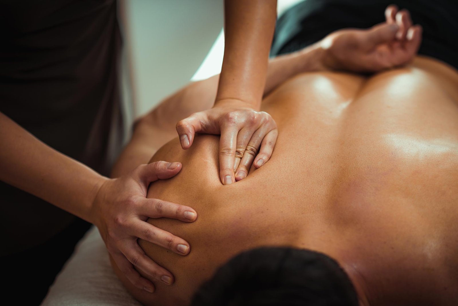 massage therapist working on patient